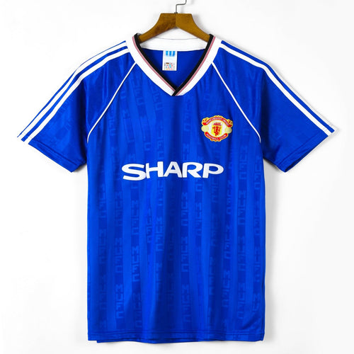 Maillot Manchester United troisième rétro 1988-1990 par Le 12 -ème Maillot, vue de face avec logo et détails du maillot.