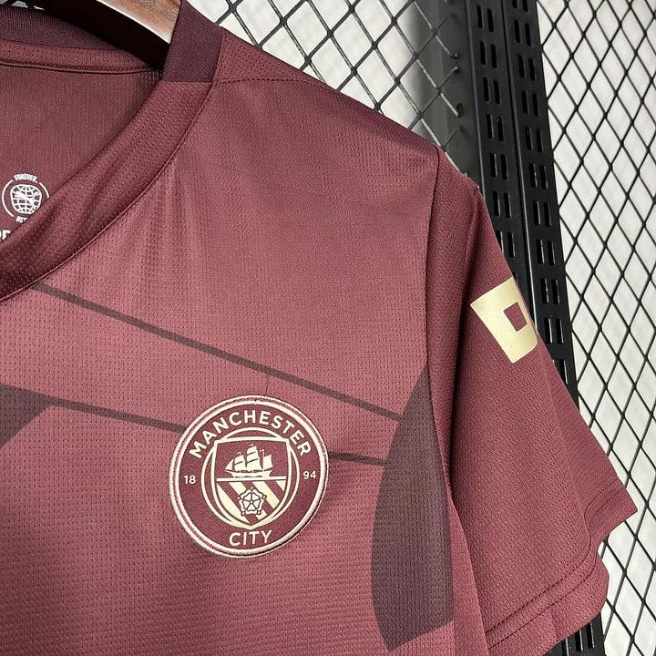 Maillot Manchester City 2024/25 de la marque Le 12 -ème Maillot, vue de face avec logo et détails du maillot.