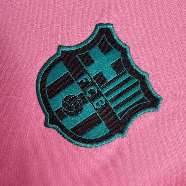 Maillot FC Barcelone 2020 2021 rose de la marque Le 12 -ème Maillot, vue de face avec logo et détails de l'équipe.