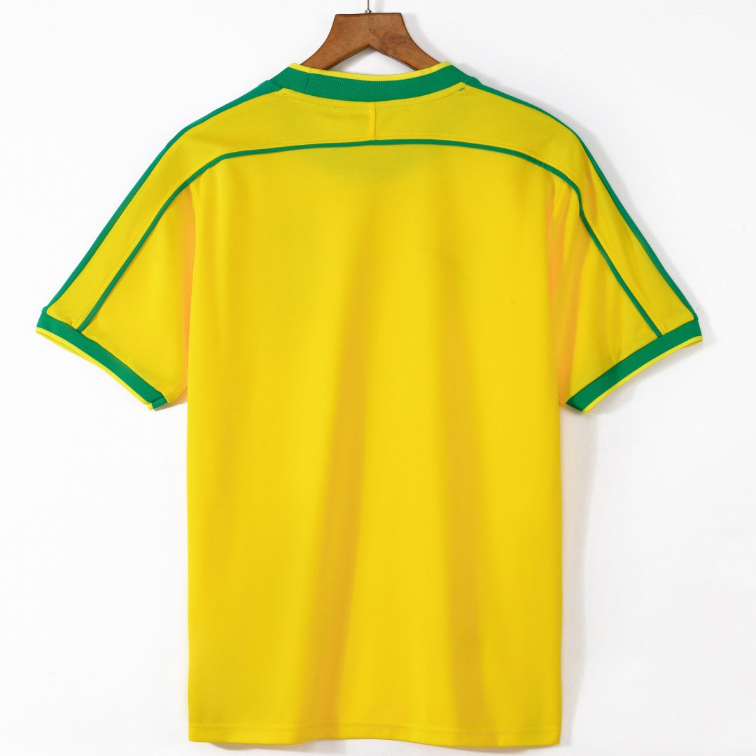 Maillot domicile Brésil rétro 1998, marque Le 12 -ème Maillot, vue de face avec logo et détails du maillot.