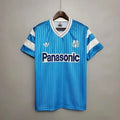 Maillot de football Marseille rétro extérieur 1990 de la marque Le 12-ème Maillot, avec logo et design vintage visible.