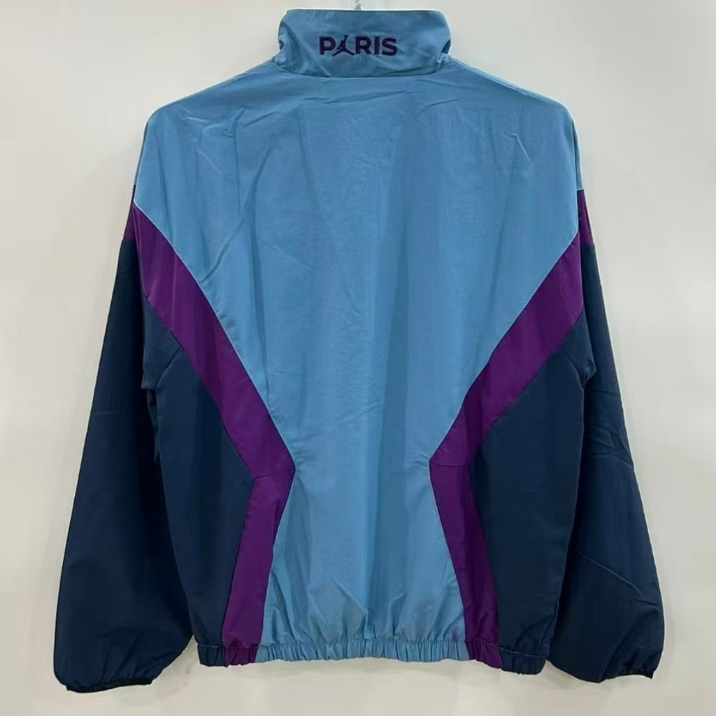 Veste coupe-vent réversible PSG bleue de la marque Le 12-ème Maillot, vue de face avec logo visible.