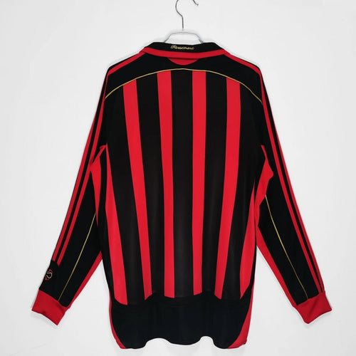 Maillot domicile rétro AC Milan 2006-2007 à manches longues, marque Le 12, en tissu bleu et noir avec logo du club.