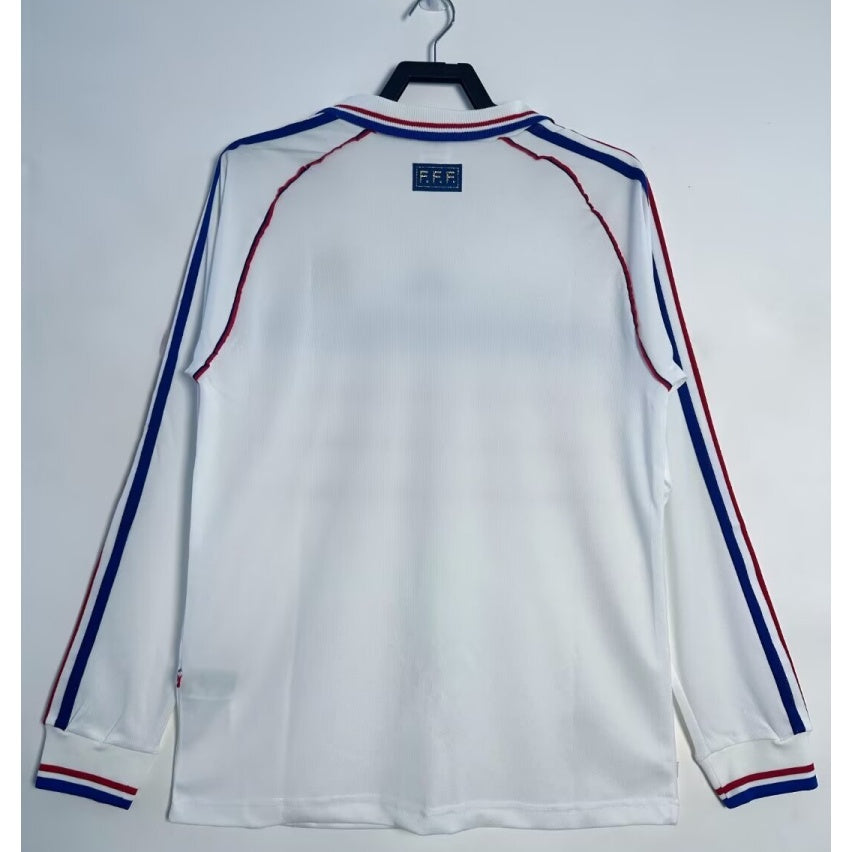 Maillot extérieur de football France 1998, manches longues, style rétro, en bleu avec logo de l'équipe nationale.