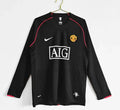 Maillot extérieur Manchester United 07-08 à manches longues, marque Le 12 -ème Maillot, en tissu rouge avec logo et détails blancs.