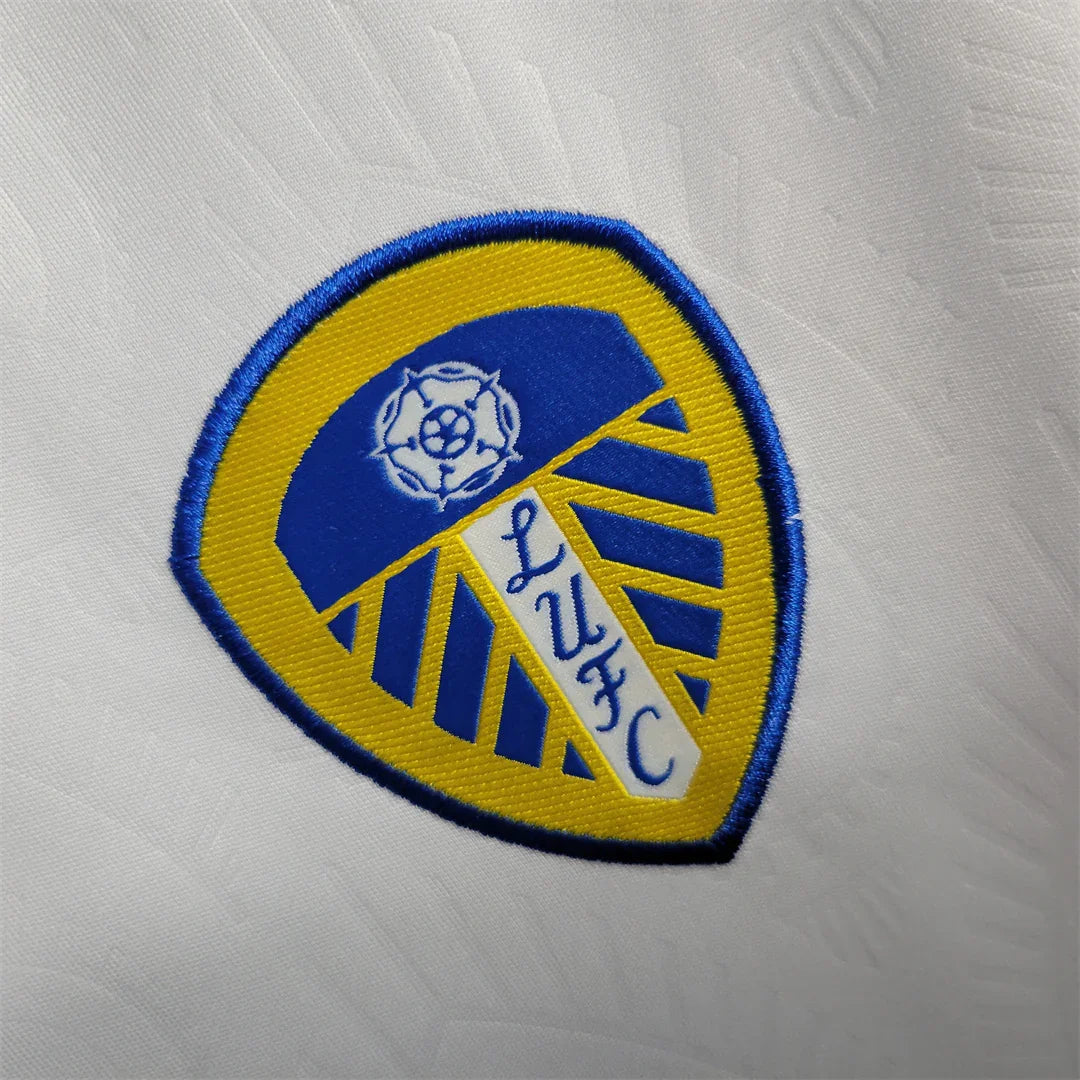 Maillot Leeds United 2023-24 par Le 12-ème Maillot, maillot de football avec logo et détails du club visible sur le tissu.
