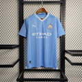 Maillot domicile Manchester City saison 2023-2024, marque Le 12 -ème Maillot, vue du devant avec logo et design officiel.