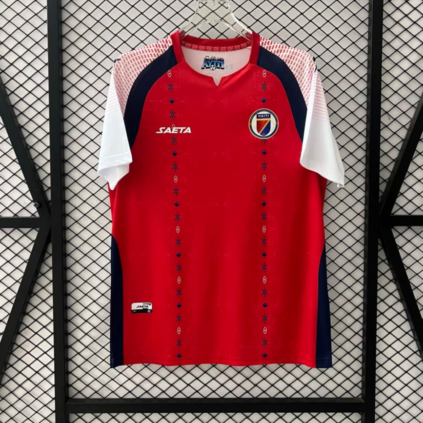 Maillot de football Haiti Third 25/26 Le 12 -ème Maillot, maillot orange avec logo national et détails en bleu.