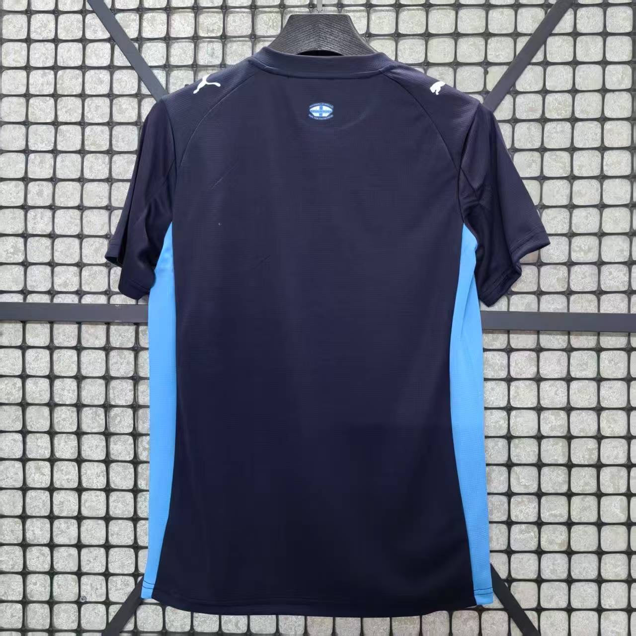 Maillot extérieur Marseille 25/26 Le 12-ème Maillot, maillot de football bleu avec logo de l'équipe, vue de face.