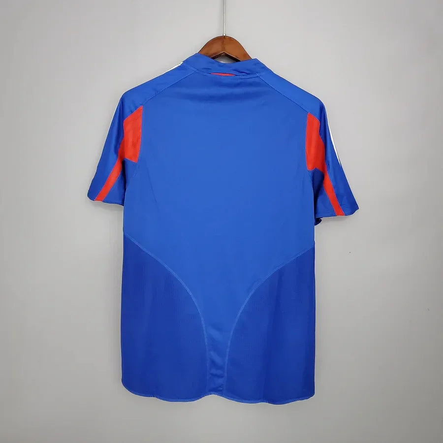 Maillot de l'équipe de France 2004 Le 12, jersey de football bleu avec logo et numéros visibles.
