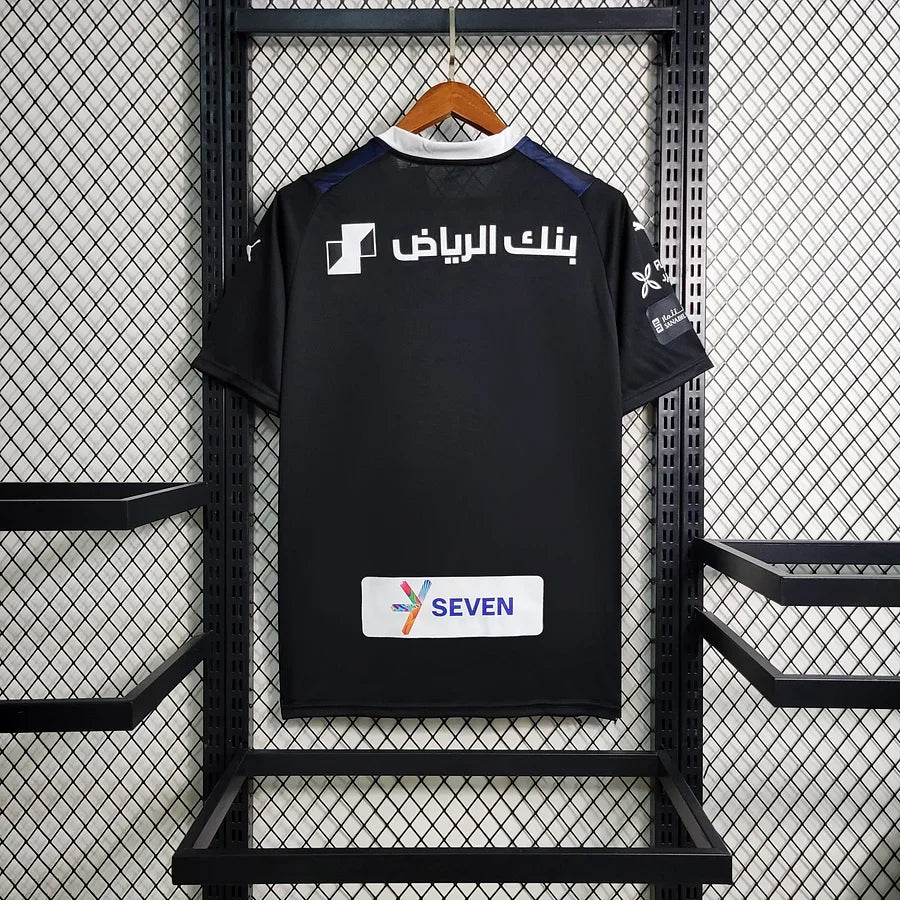 Maillot extérieur de l'équipe Al Hilal 2023/24 Le 12, maillot de football avec logo et détails colorés, vue de face.