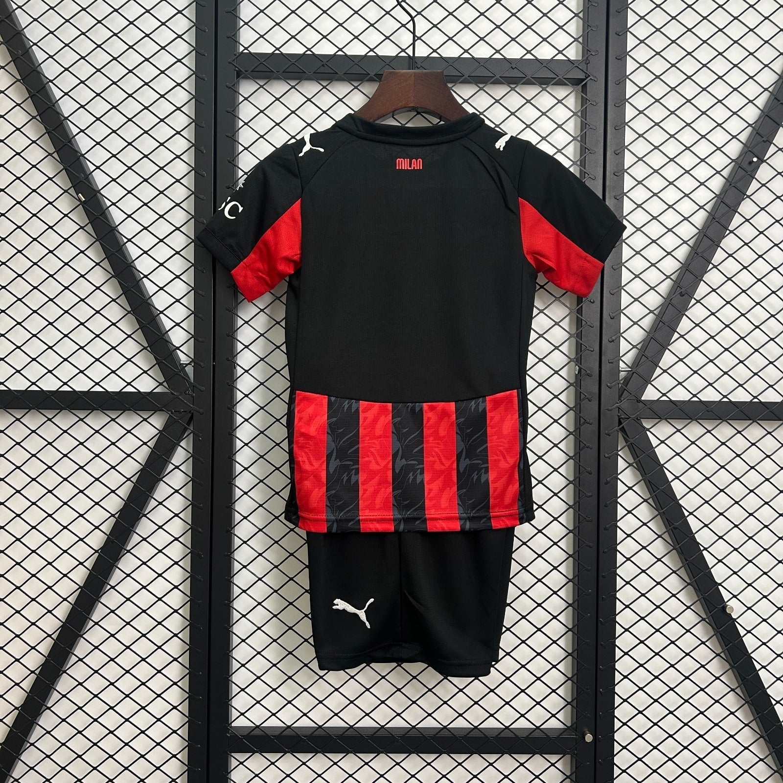 Maillot domicile AC Milan 25-26, marque Le 12 -ème Maillot, en tissu rouge avec détails noirs et logo du club visible.