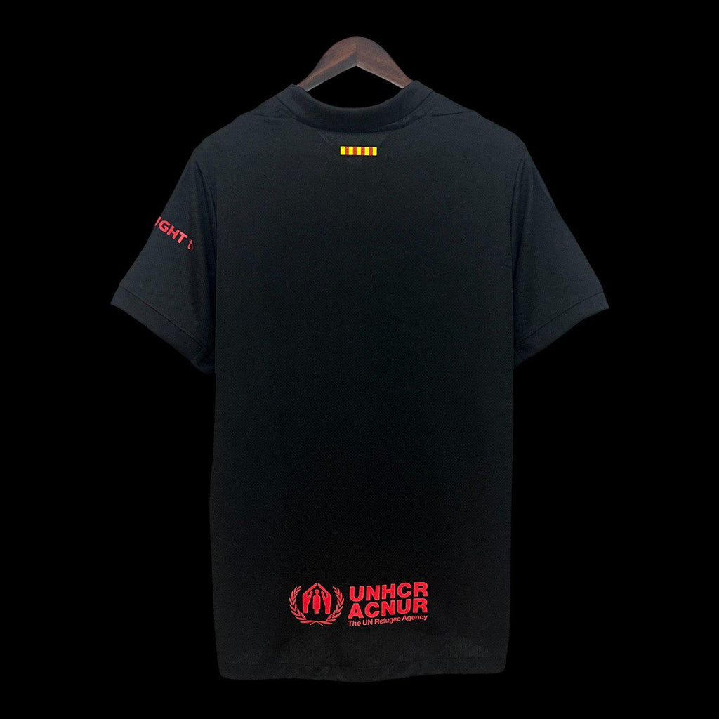 Maillot de football Barcelone 24/25 noir, modèle spécial de la marque Le 12, porté par le joueur sur le terrain.