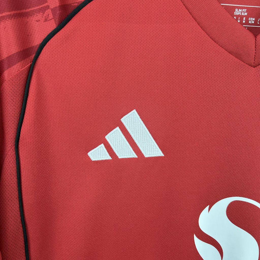 Maillot Manchester United 2025-26 Le 12 -ème Maillot, devant avec logo et numéro, en tissu rouge et blanc.