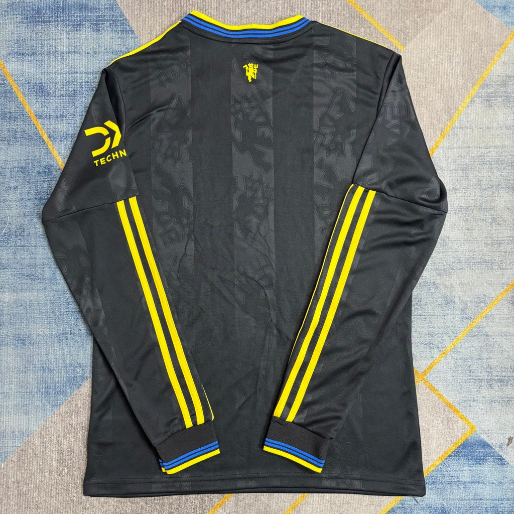 Maillot Manchester United third 25/26 à manches longues, marque Le 12 -ème Maillot, vue de face avec logo et design distinctif