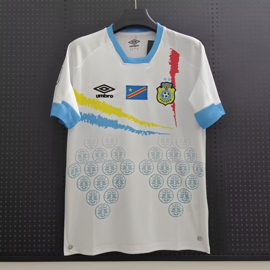 Maillot extérieur 24/25 du Congo, marque Le 12 -ème Maillot, en tissu bleu avec motifs et logo national visible.