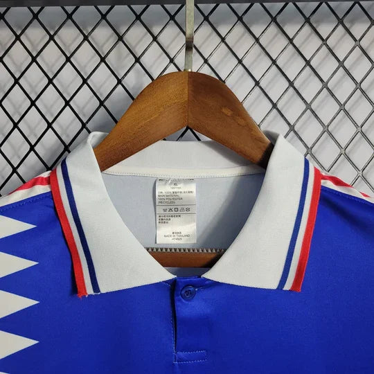 Maillot rétro de l'équipe de France 1994 de la marque Le 12, vue de face avec logo et design vintage.