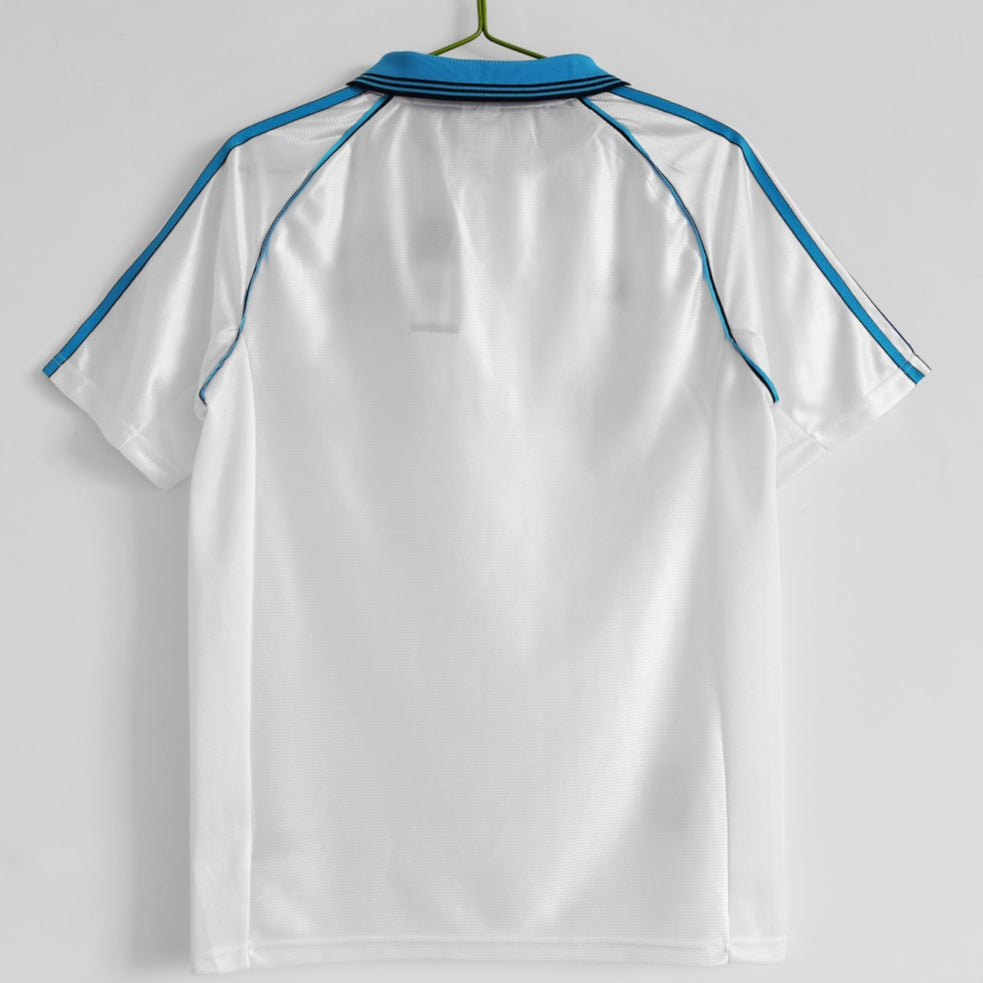 Maillot domicile rétro de l'équipe Marseille 1998-1999, marque Le 12 -ème Maillot, vue de face avec logo et détails du maillot.