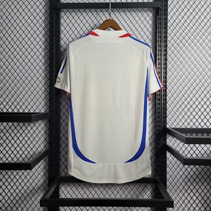 Maillot rétro de l'équipe de France 2006, marque Le 12 -ème Maillot, vue frontale avec logo et design vintage.