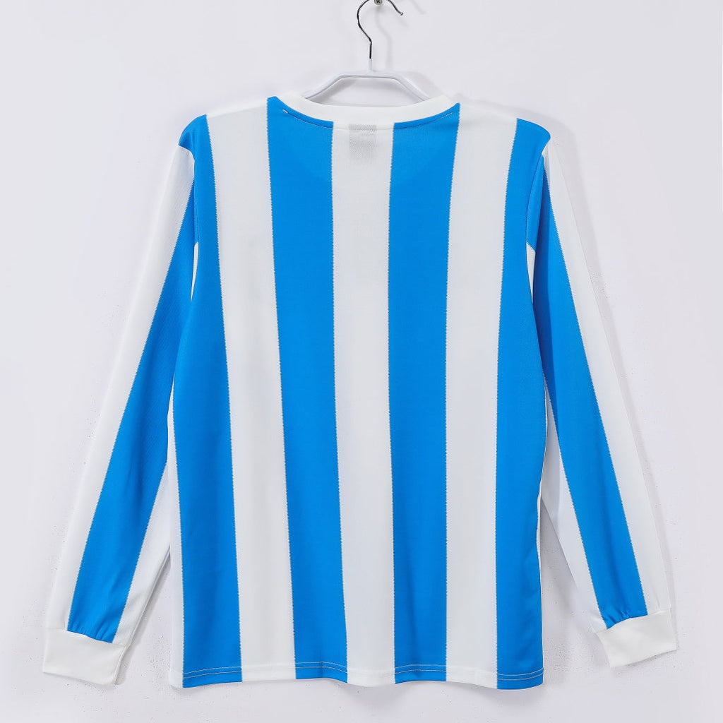 Maillot Argentine domicile rétro 1986 à manches longues, couleur bleu et blanc, marque Le 12 -ème Maillot, vue de face.