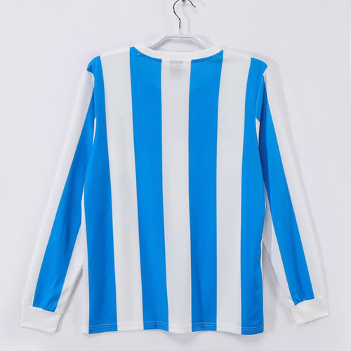 Maillot Argentine domicile rétro 1986 à manches longues, couleur bleu et blanc, marque Le 12 -ème Maillot, vue de face.