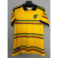 Maillot domicile Jamaica 25/26 Le 12 -ème Maillot, maillot de football jaune et vert avec logo et détails de l'équipe.