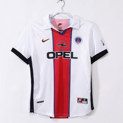 Maillot extérieur rétro du PSG 1998-1999, marque Le 12-ème Maillot, avec logo et design vintage visible sur le maillot.