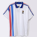 Maillot rétro extérieur de l'équipe de France 1994, marque Le 12 -ème Maillot, vue du maillot bleu avec logo officiel.