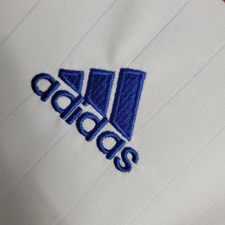 Maillot rétro de l'équipe de France 2006, modèle Le 12 -ème Maillot, vue frontale avec logo et détails du design.