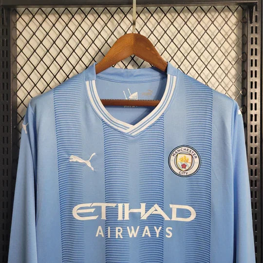 Maillot Manchester City manches longues 2023 2024 Le 12 -ème Maillot, maillot de football avec logos et détails visibles.