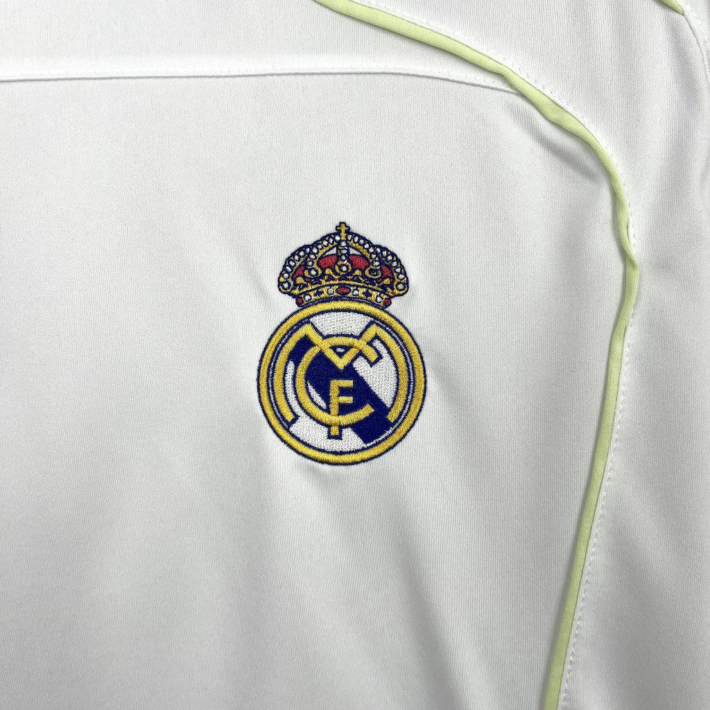 Maillot Real Madrid 2025-26 Le 12 -ème Maillot, maillot de football blanc avec logo du club et détails en bleu.