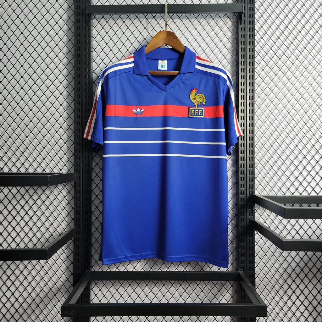 Maillot rétro de l'équipe de France 1985/86 de la marque Le 12, maillot de football vintage avec logo et design d'époque.