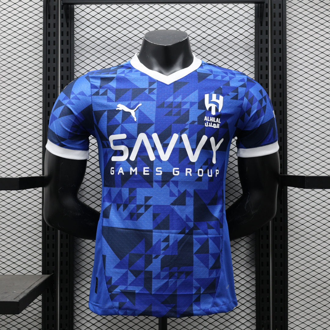 Maillot de football AL-Hilal 2024-25, marque Le 12, en tissu bleu avec logo et détails sportifs visibles.