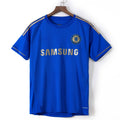 Maillot domicile rétro Chelsea 2012-2013 de la marque Le 12-ème, vue de face avec logo et détails du maillot.