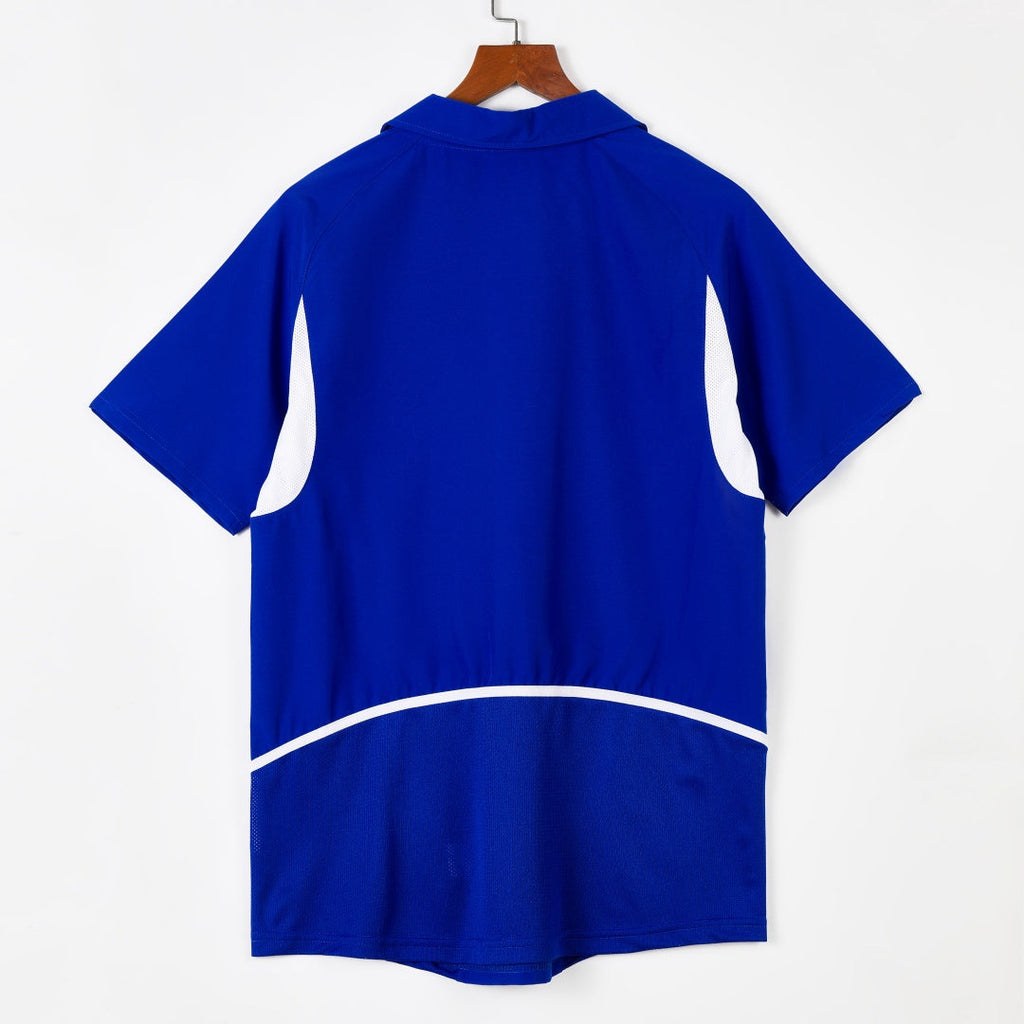Maillot extérieur rétro du Brésil 2002, marque Le 12, devant avec logo et couleurs traditionnelles brésiliennes.