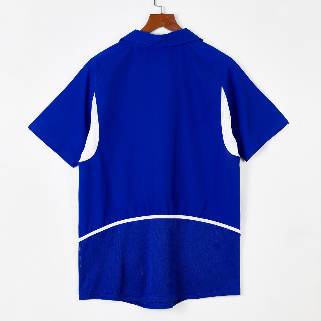 Maillot extérieur rétro du Brésil 2002, marque Le 12, devant avec logo et couleurs traditionnelles brésiliennes.