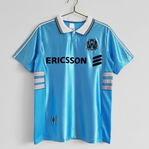 Maillot extérieur rétro de 1998-1999 de Marseille, marque Le 12ème Maillot, avec design vintage et couleurs authentiques.