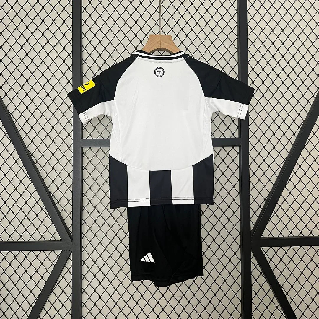 Kit enfant Newcastle 2024-25 de Le 12 -ème Maillot, maillot et short rouge et bleu visible sur l'image.