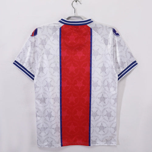 Maillot extérieur rétro du Paris Saint-Germain 1994-1995, marque Le 12, avec le logo et le design classique de l'époque.