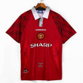 Maillot domicile rétro Manchester United 1996-1997, marque Le 12, vue de face avec logo et détails du maillot.