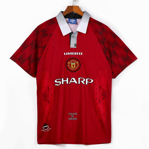 Maillot domicile rétro Manchester United 1996-1997, marque Le 12, vue de face avec logo et détails du maillot.