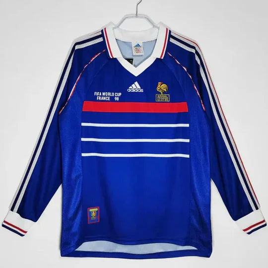 Maillot rétro de l'équipe de France 1998 à manches longues, marque Le 12 -ème Maillot, visible avec détails du design.