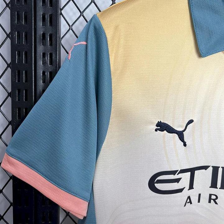 Maillot de football Manchester City 2024-2025 quatrième, Le 12 -ème Maillot, vue du devant avec logo et design bleu.