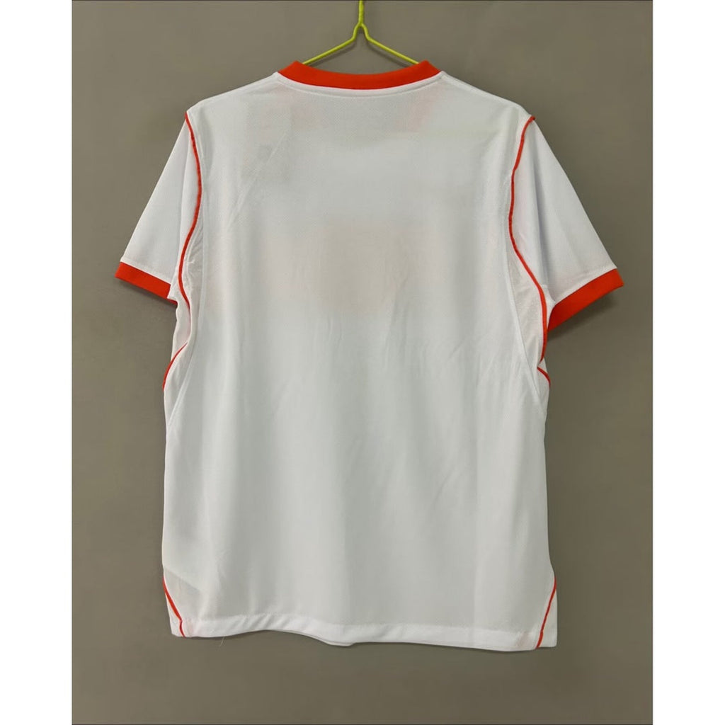 Maillot extérieur 25/26 de l'équipe Pays-Bas, marque Le 12, en tissu orange avec logo officiel visible.