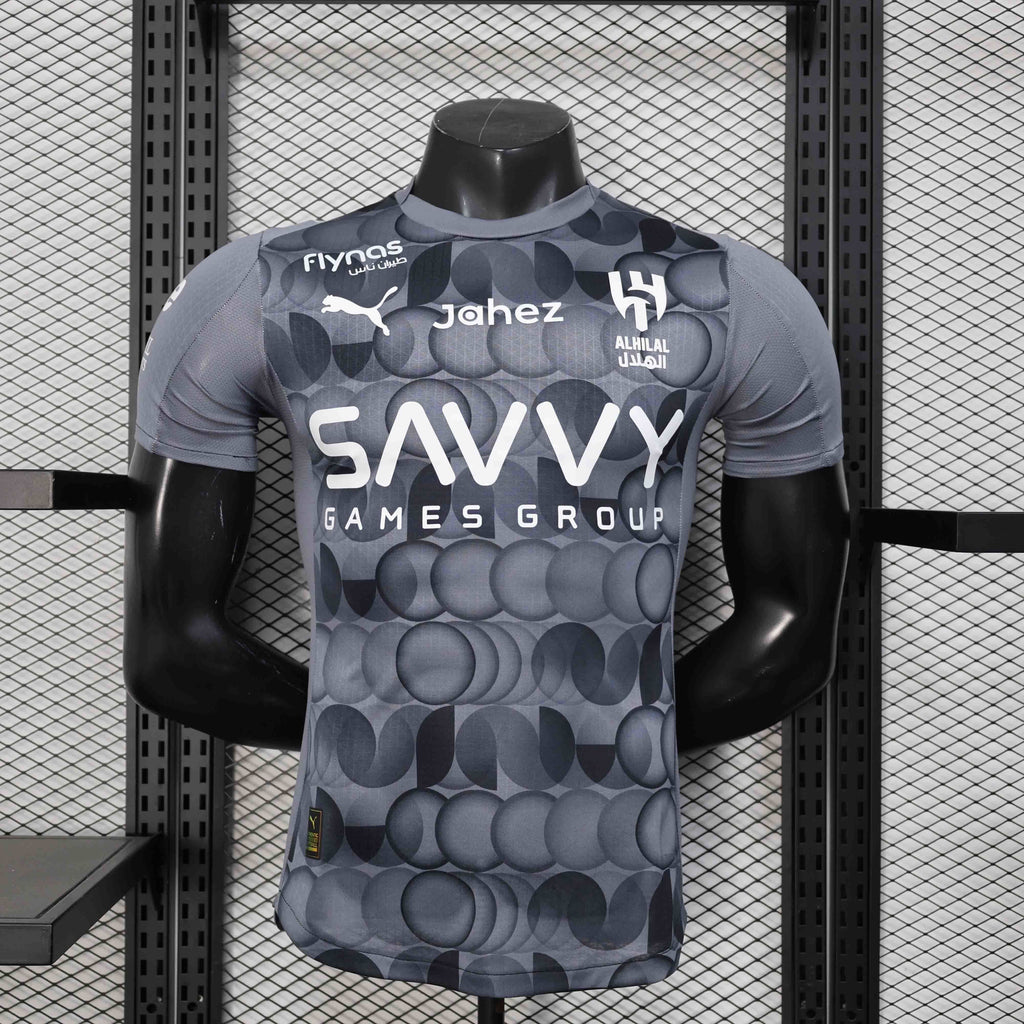 Maillot de football AL-Hilal 2025-26, marque Le 12 -ème Maillot, en tissu bleu avec logo de l'équipe et détails de style.
