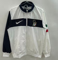 Veste coupe-vent réversible Le 12 -ème Maillot, veste légère avec design italien, visible côté extérieure en tissu noir et coloré.