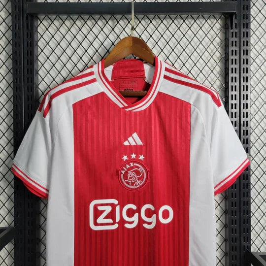 Maillot domicile de l'Ajax 2023-2024, marque Le 12-ème Maillot, vue de face avec logo et design officiel.