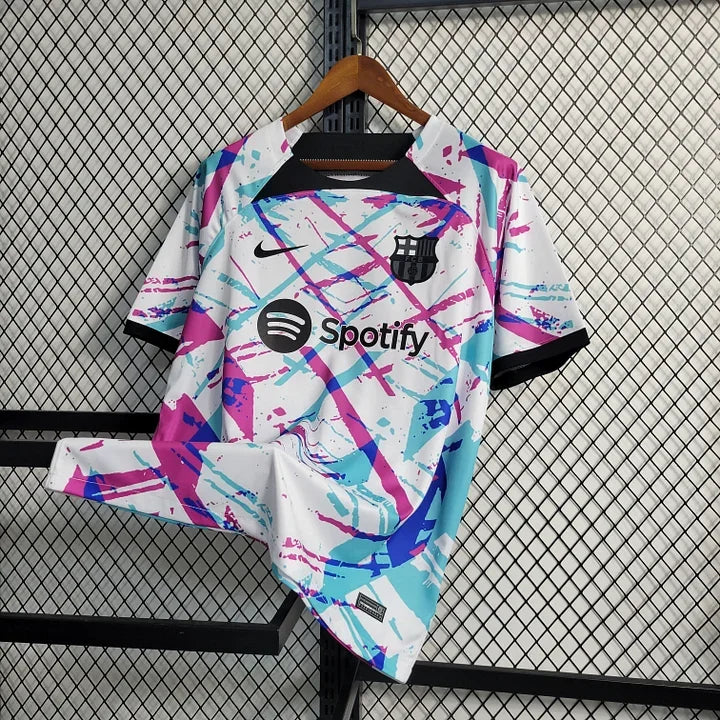 Maillot d'entraînement FC Barcelone 2023-2024 Le 12, logo Barça, couleurs bleues et rouges, tissu sportif.