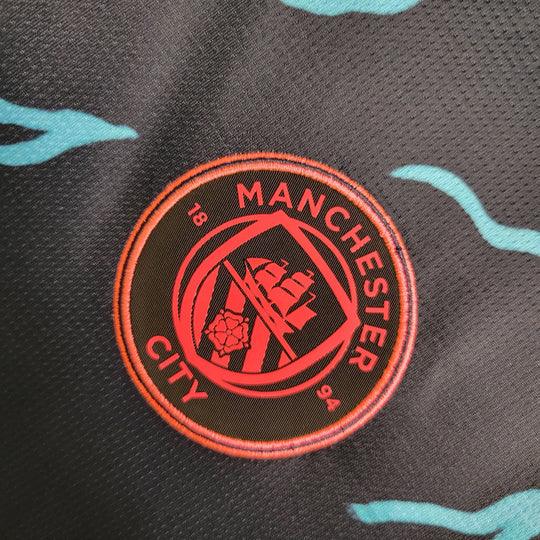 Maillot extérieur Manchester City 2023 2024 manches longues, marque Le 12 -ème Maillot, en tissu bleu avec logo sur la poitrine