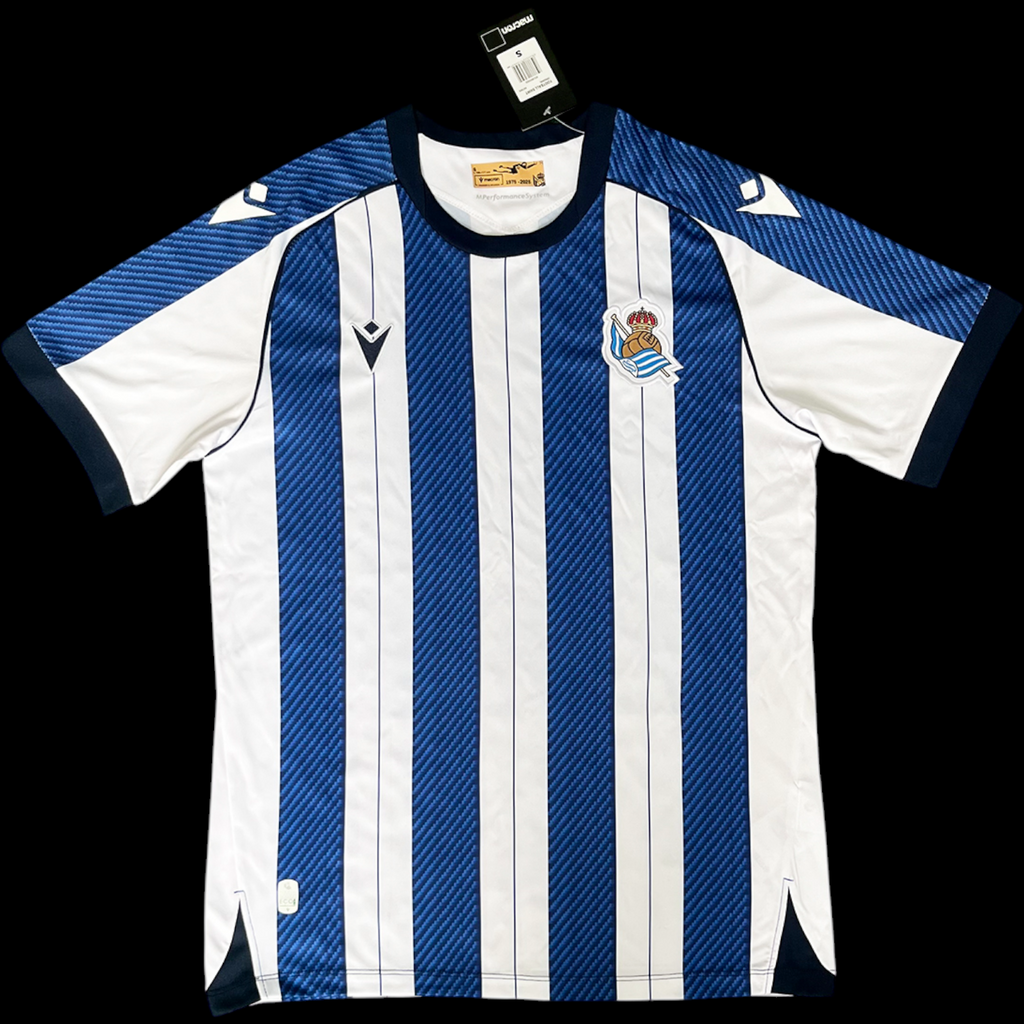 Maillot domicile 25/26 de la Real Sociedad, marque Le 12-ème Maillot, vue de face avec logo et détails de l'équipe.